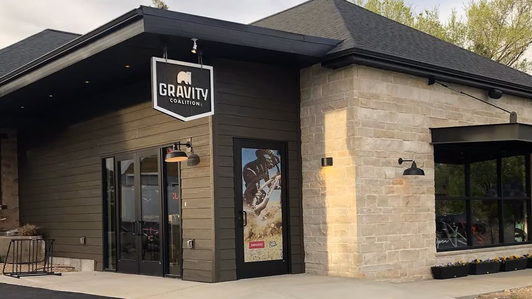 The Gravity Coalition storefront in Midway, with the shield sign hanging over the door